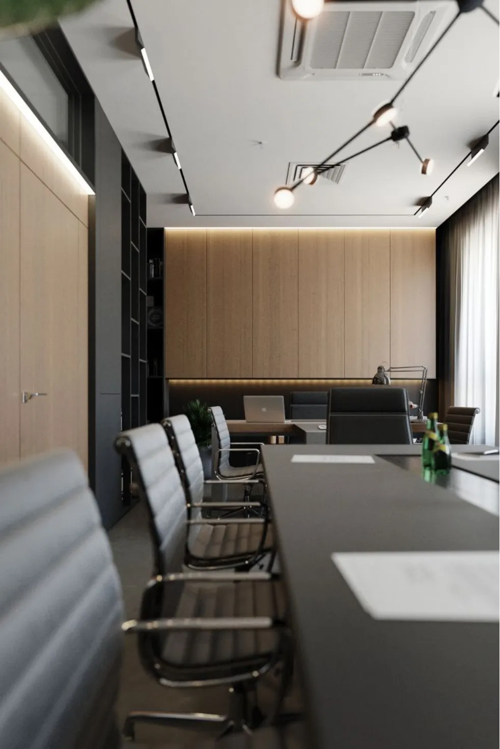 Modern office meeting room with black table, grey chairs, wood wall panels, and ceiling light