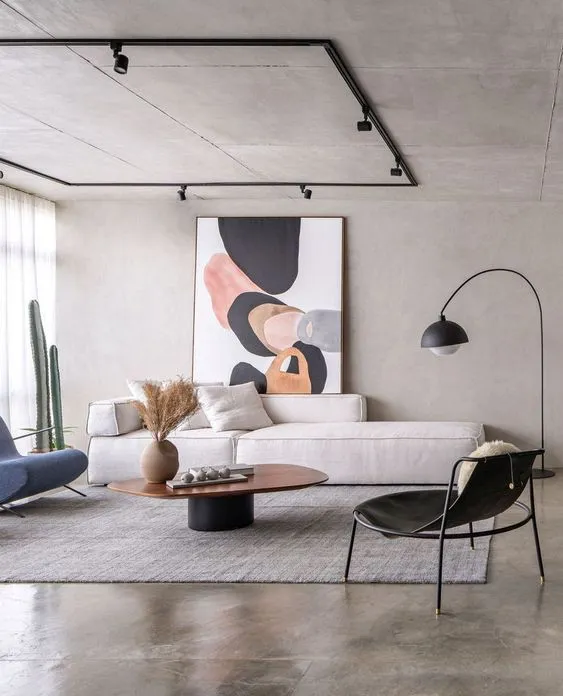 Modern living room with white sofa wooden table grey rug floor lamp large abstract art