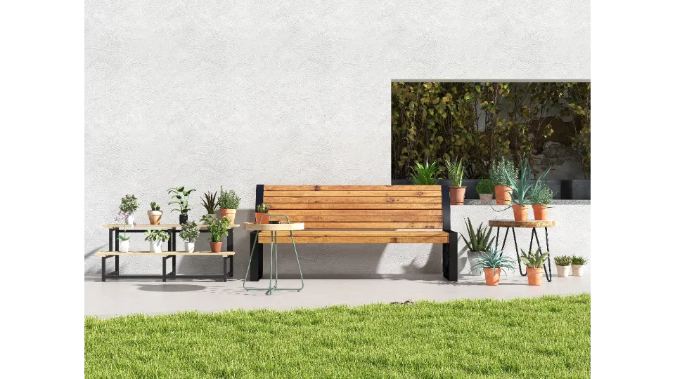 Outdoor wooden bench with potted plants on shelves against a white wall with green grass